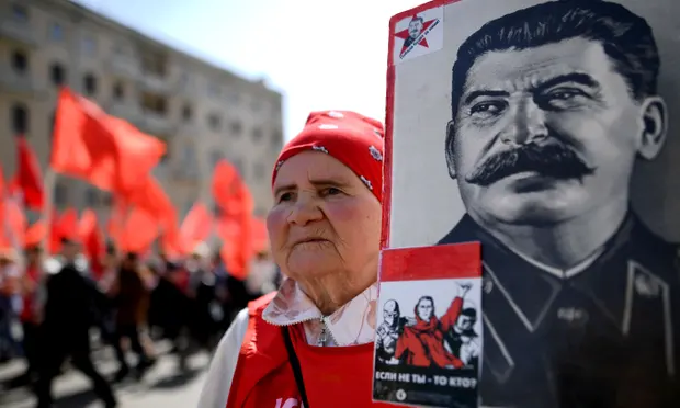 A Communist party activist with a banner of Joseph Stalin at a May Day rally in Moscow. Photograph: Kirill Kudryavtsev/AFP/Getty Images